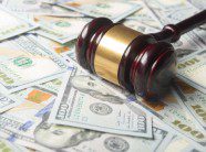 gavel on top of settlement money